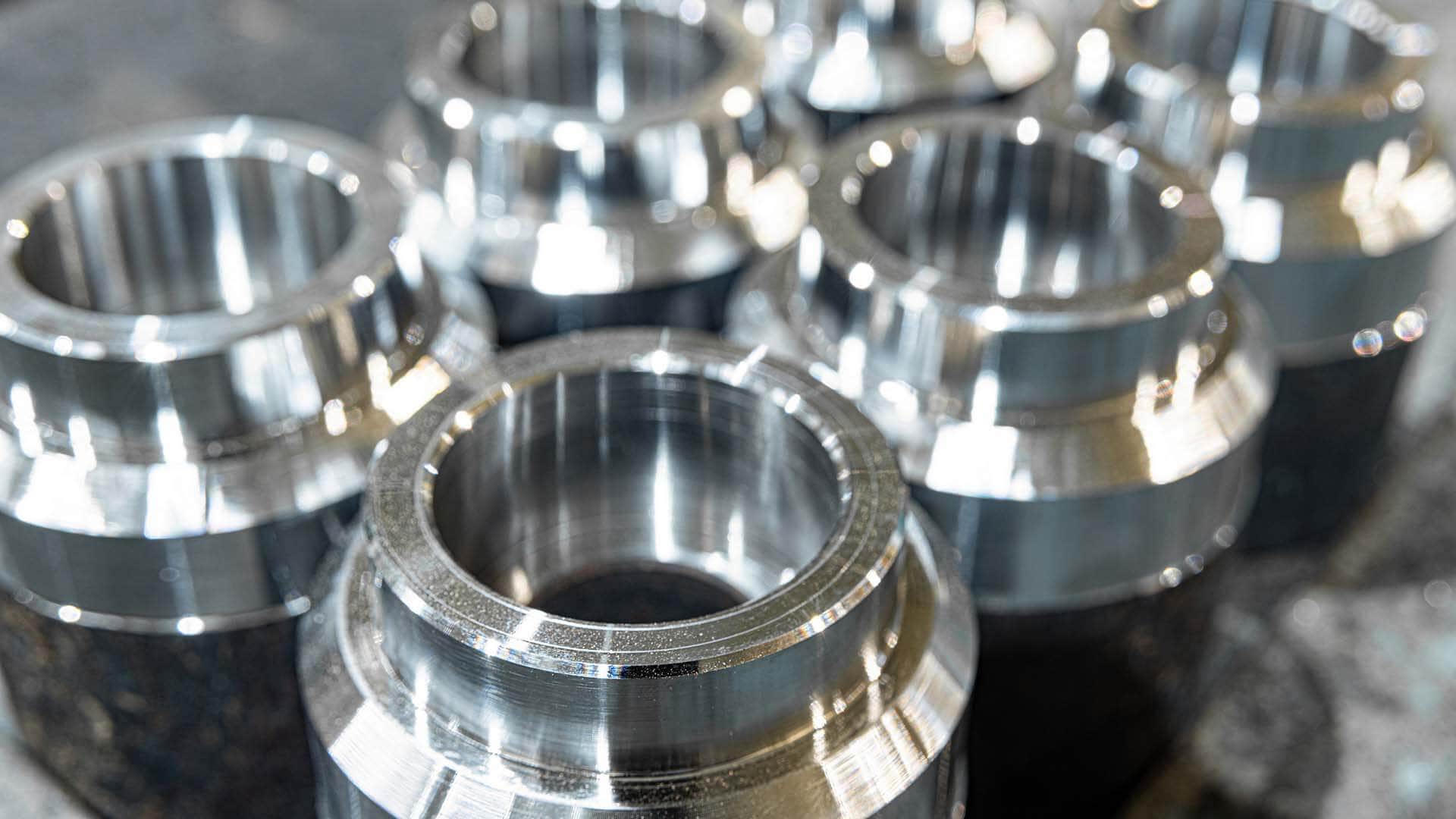 Rows of precision machined cylindrical metal components